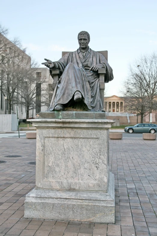 a statue is shown with a car in the background