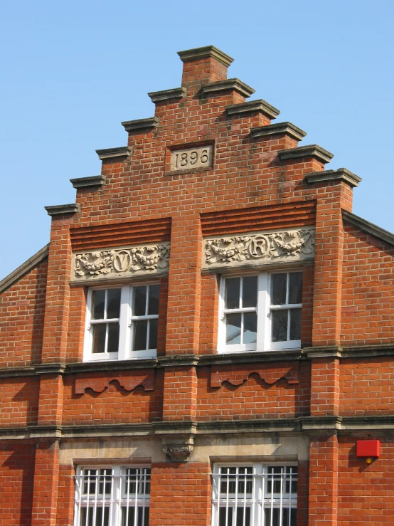 an old brick building has ornate decorations on it