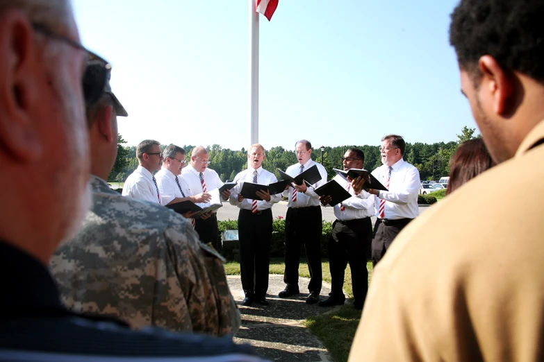 military personnel stand in formation during an outdoor ceremony