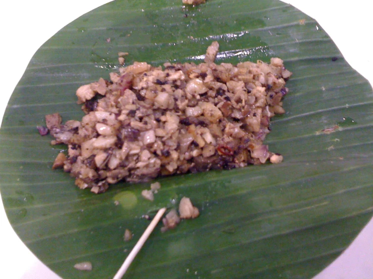 food items are placed on a large leaf