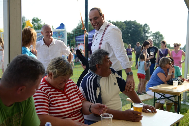 a man stands on stage at an outdoor event