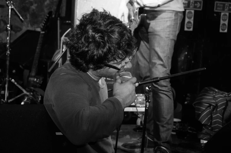 a man in a shirt holding a microphone up to his face