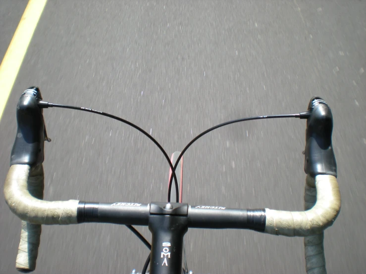 the view from the front of a bicycle on the road