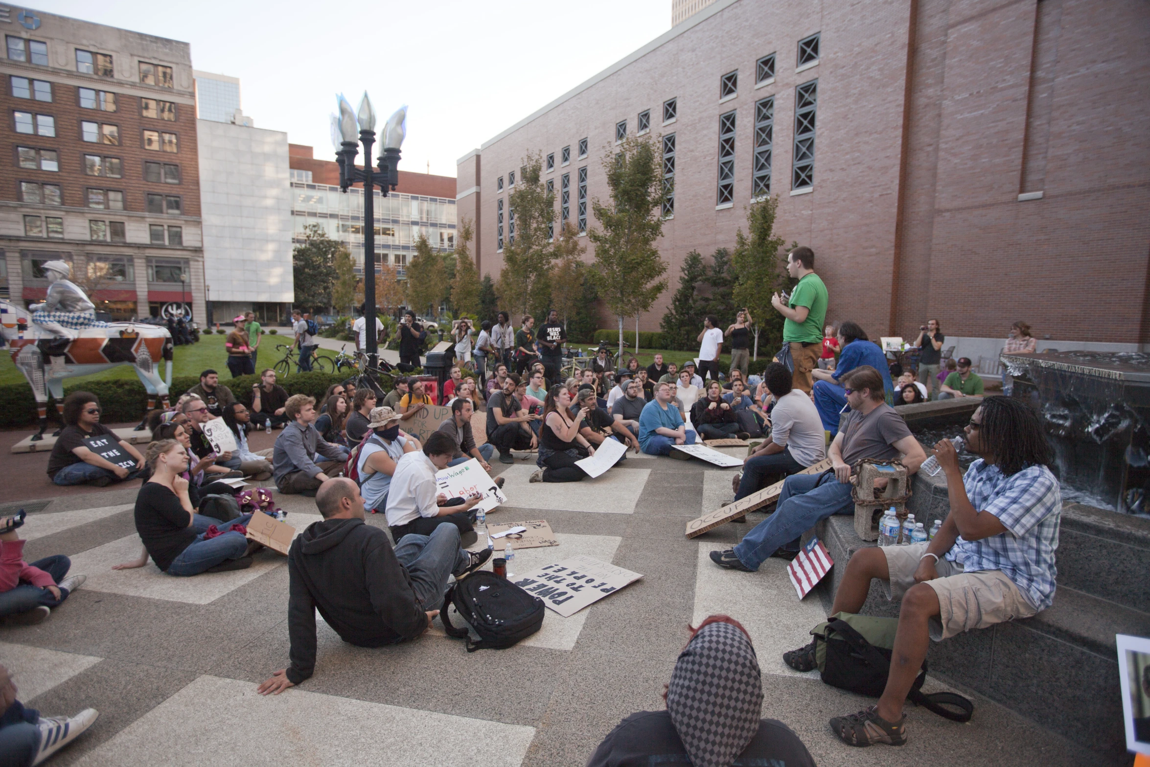 several people sitting on the ground around a woman