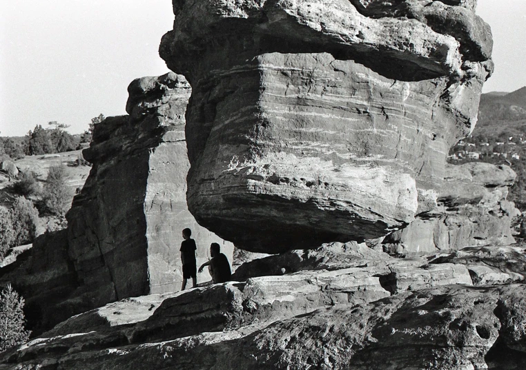 people are walking in the rocks next to each other