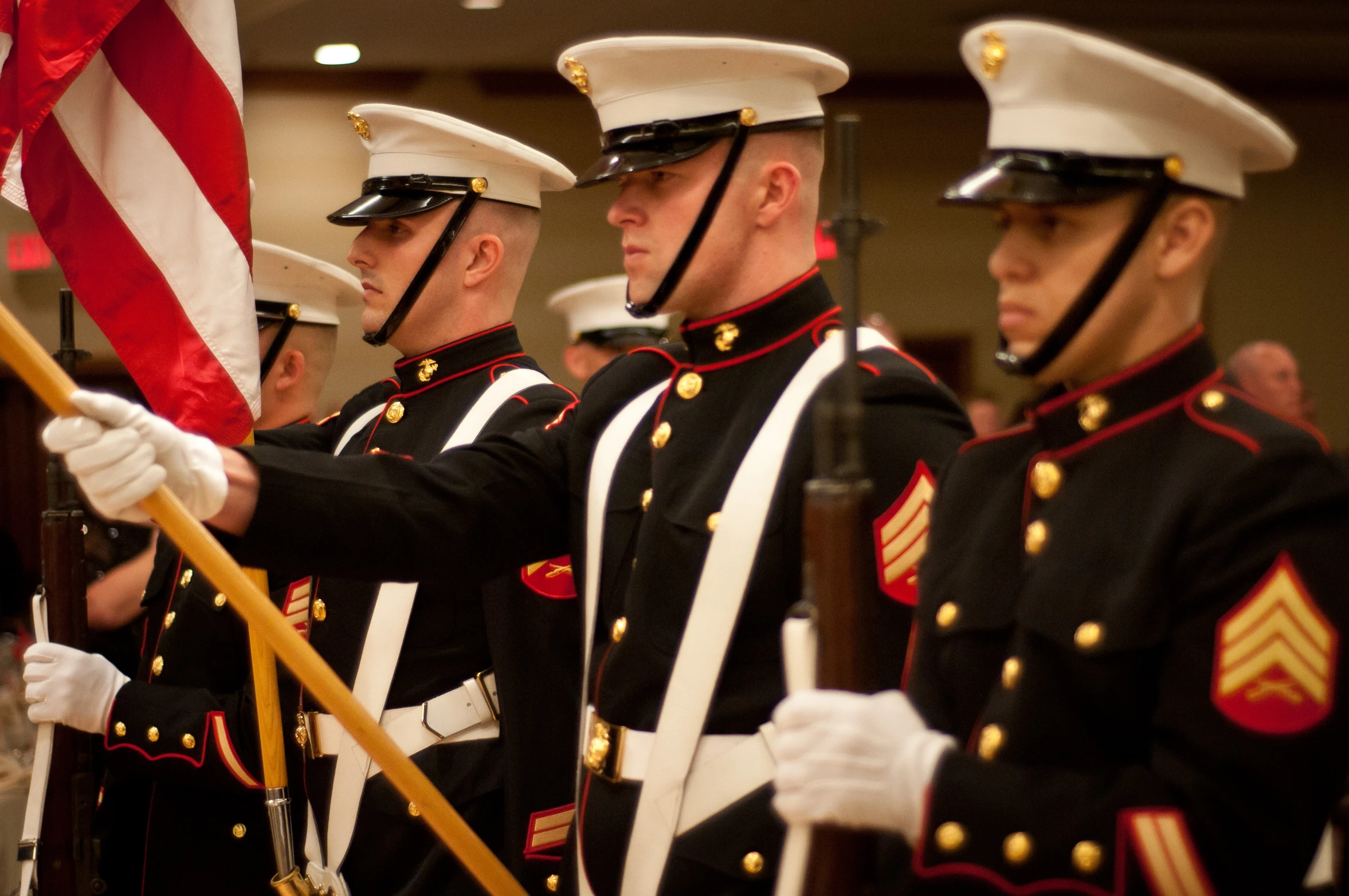 a man in a blue uniform holds the flag