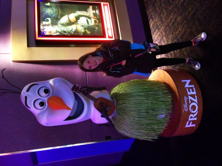 a woman standing in front of a frozen food sculpture