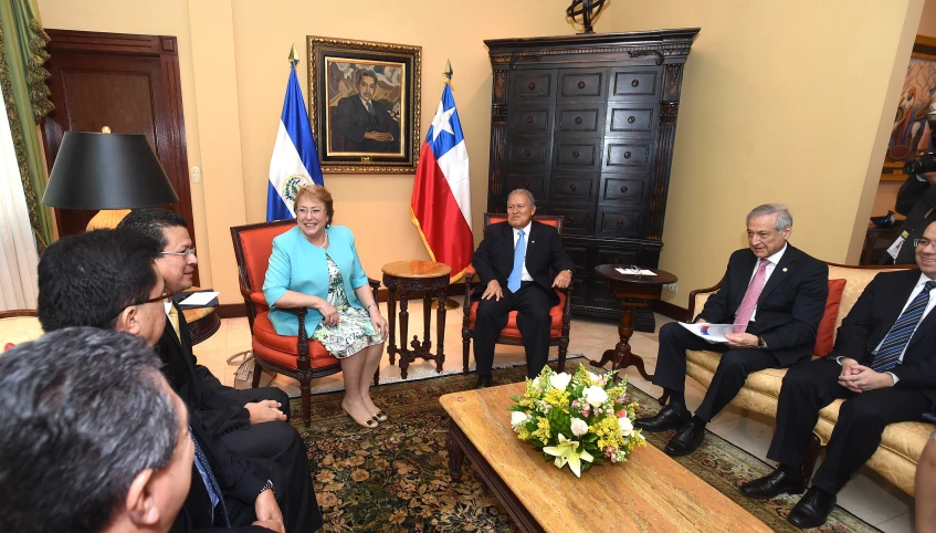 people sitting down in chairs and talking to each other