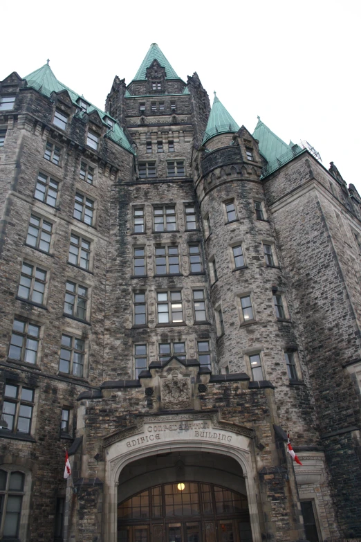 an old castle type building with windows and a clock