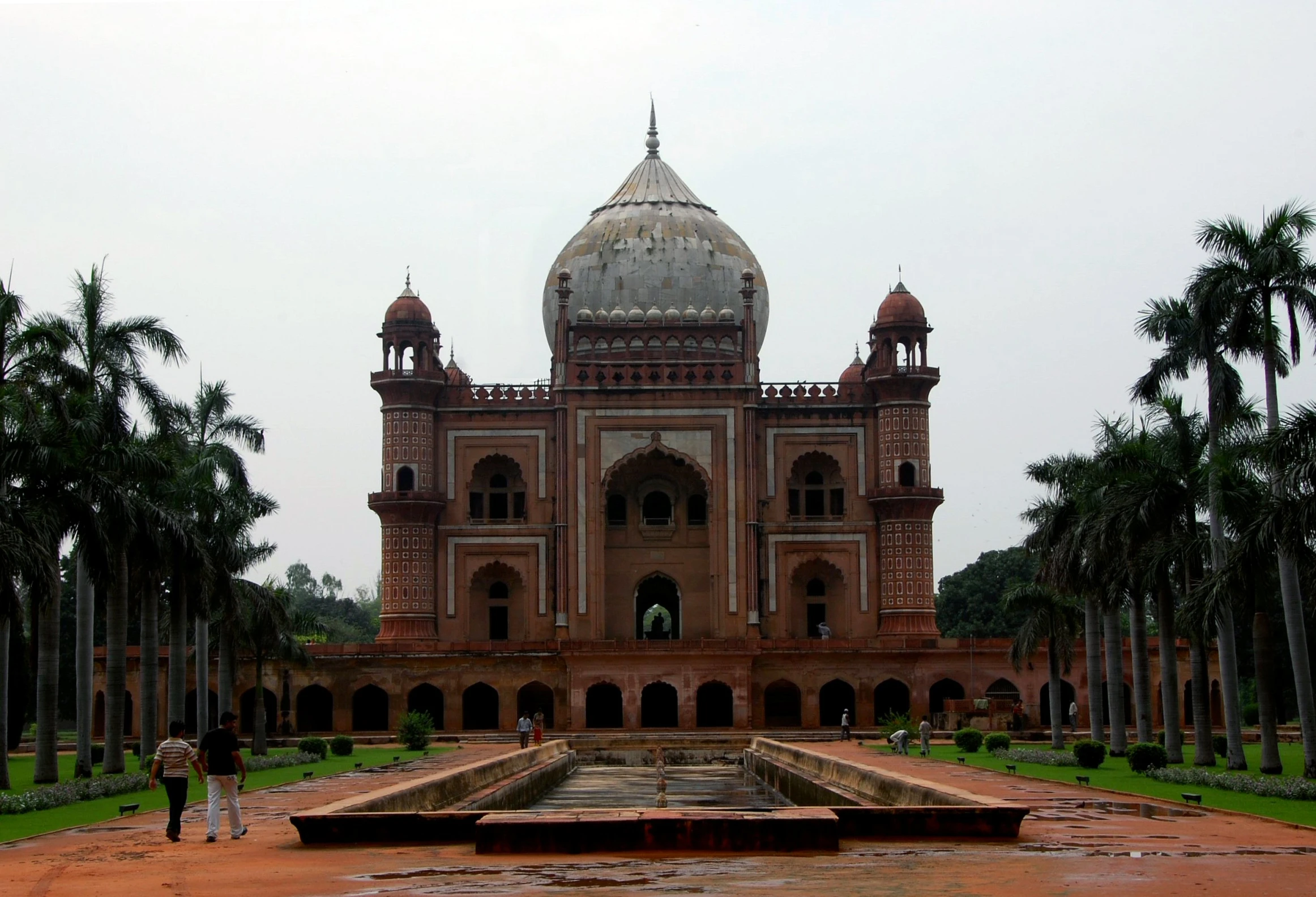 an old building with many trees and bushes