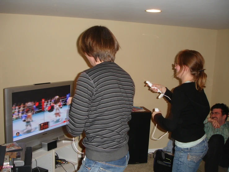 a boy and a girl are playing a wii video game