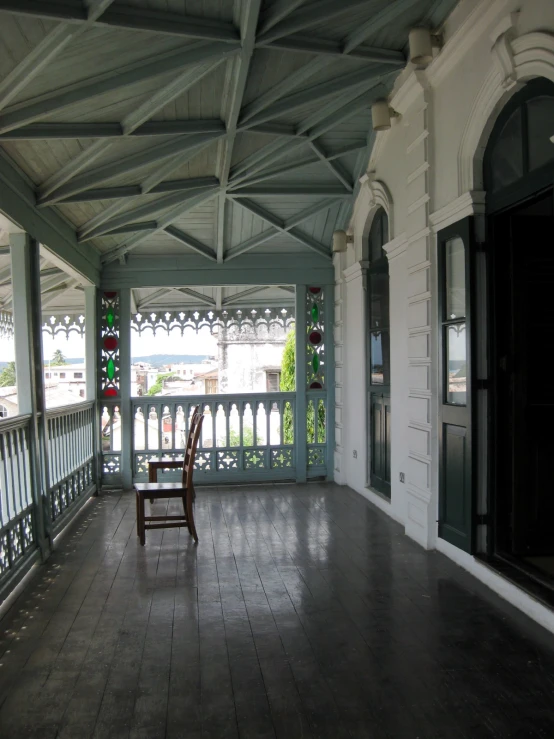 an empty chair is sitting on the outside porch