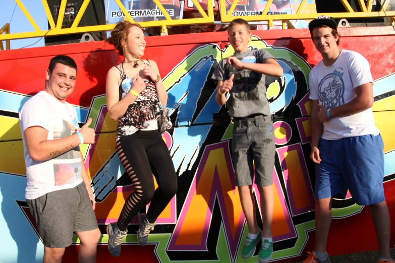 three people are standing in front of a building