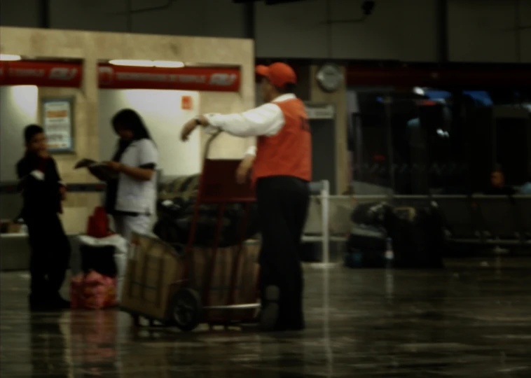 people with luggage standing around in an airport