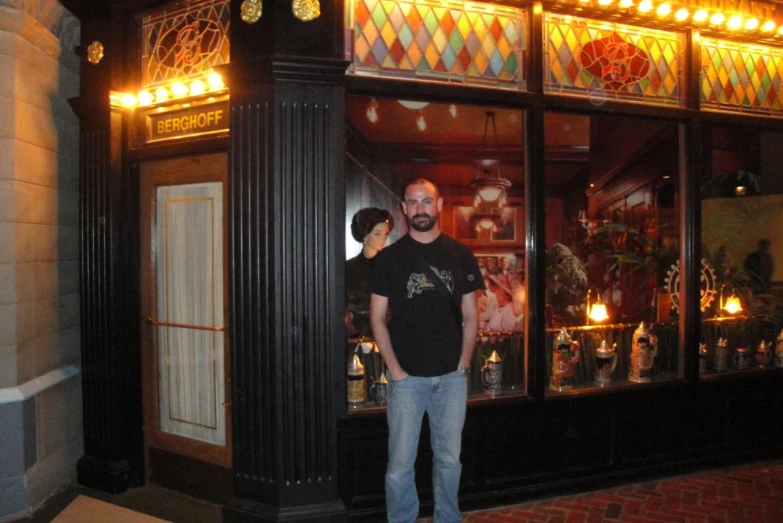 a man holding his arms around another man who is looking in a store window