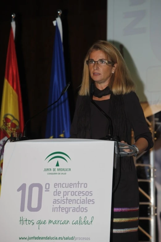 a woman is making a speech at a podium