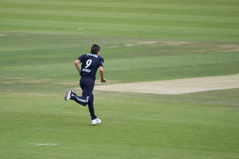 a player running across a field of grass