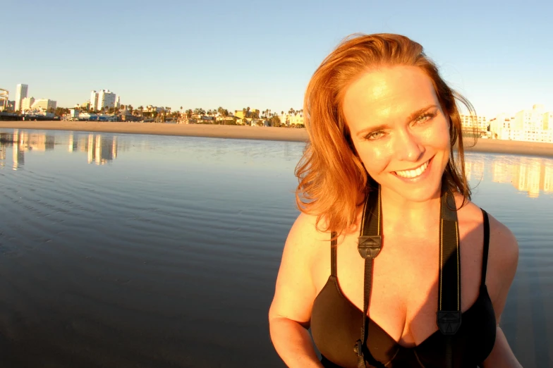 a woman standing on the shore with her mouth open