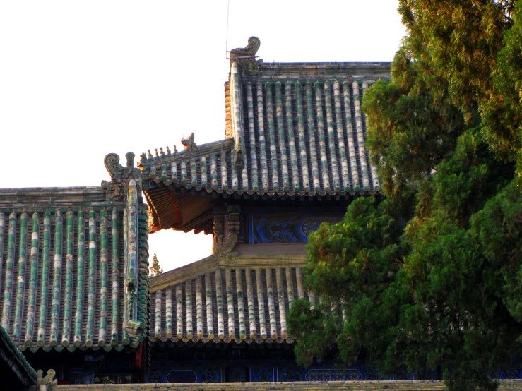 a building with chinese tiles with a clock tower on it