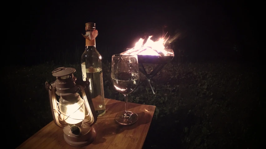 a wine bottle and wine glasses on a wooden table