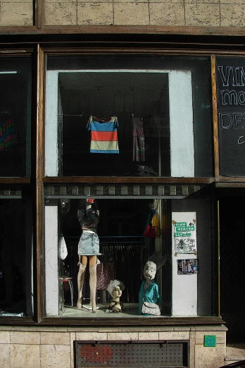 an old fashion store displays dummy mannequins and clothes