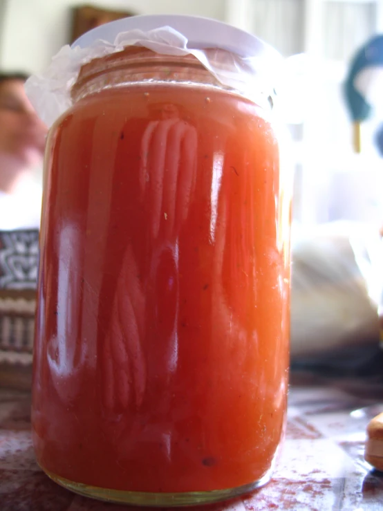 a jar sitting on a table with food inside of it