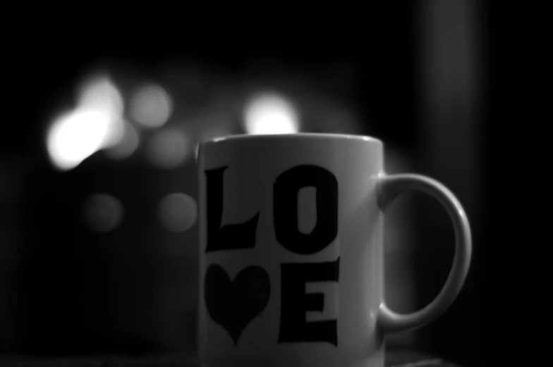 a coffee cup with a love word printed on it