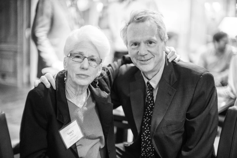 two people in formal attire pose for a picture