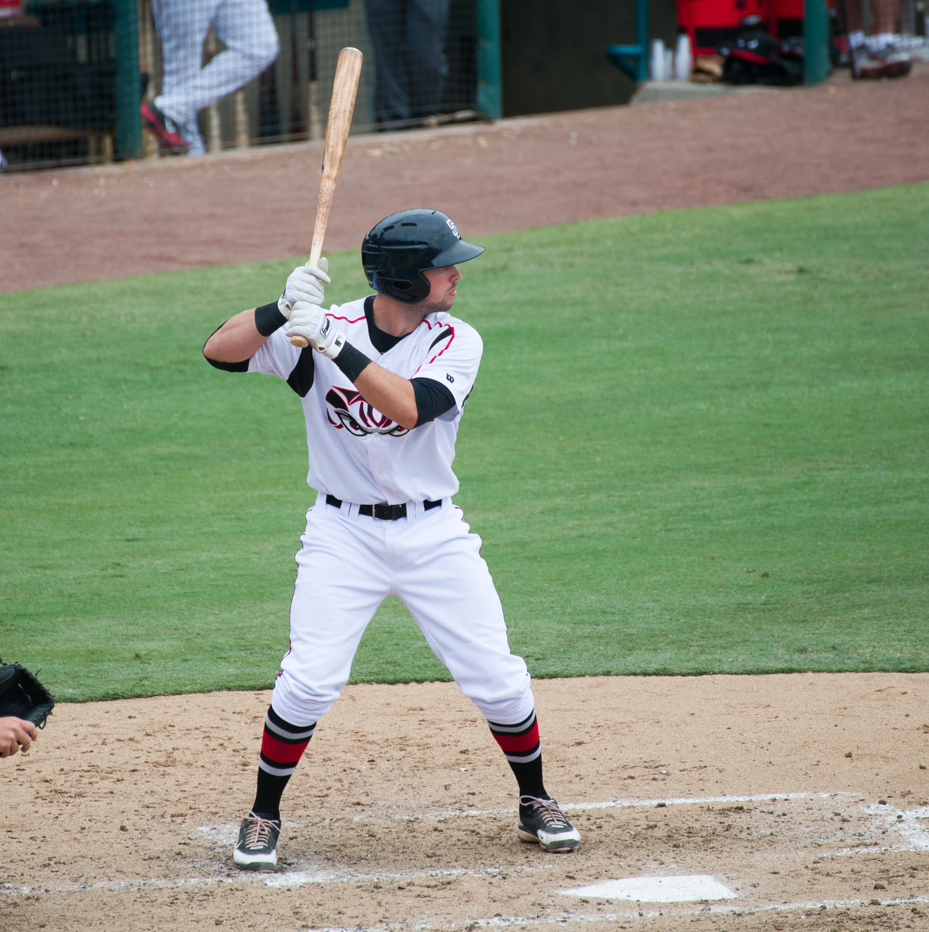 baseball player standing and holding his bat ready to swing