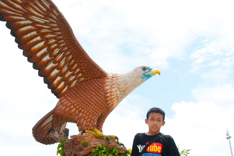 a man with a big brown eagle statue