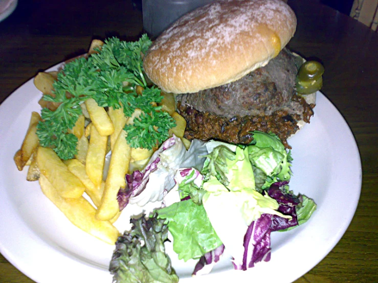 this is a hamburger, fries, and lettuce on a plate