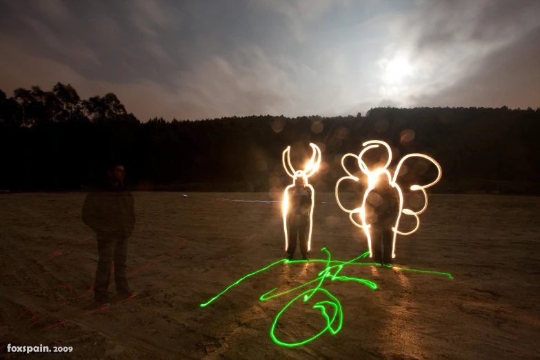 people are projected onto the ground with lights