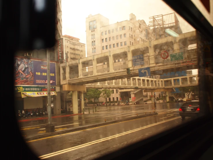 a city street filled with traffic on a rainy day