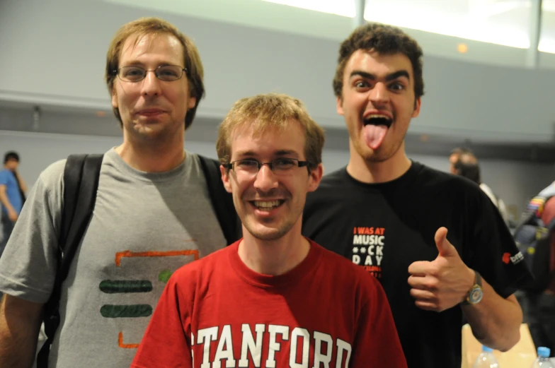 three men with glasses standing next to each other