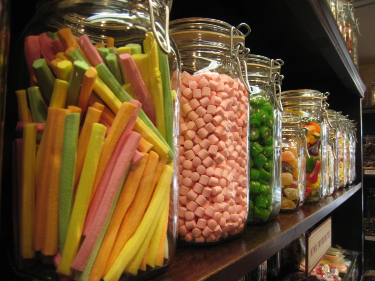 a group of large containers filled with candy