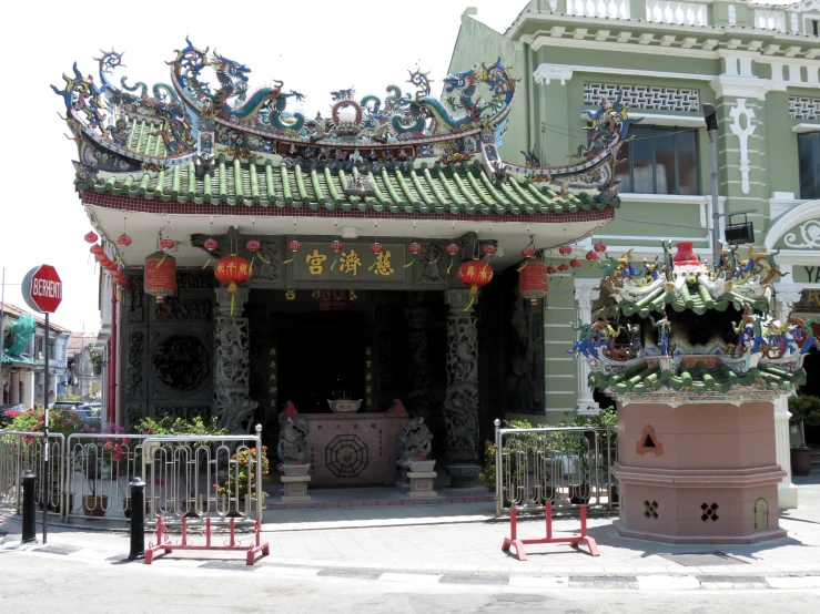 an oriental style structure with decorations hanging from the roof