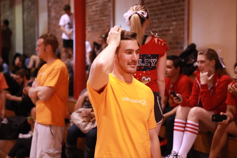 a young man who is trying on some kind of hair