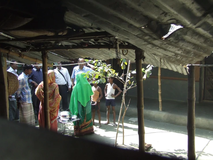 people are gathered outside the hut with open doors