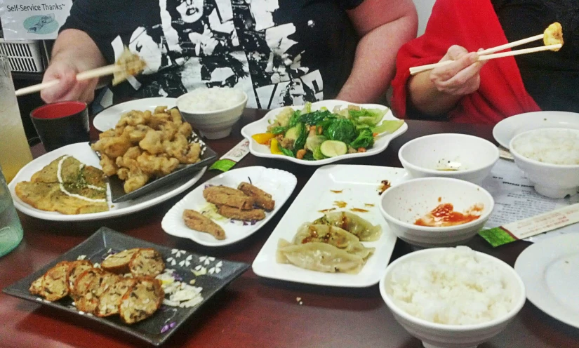 an arrangement of chinese food at a restaurant