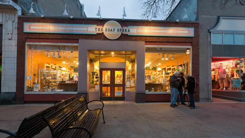 two people are standing in front of the store