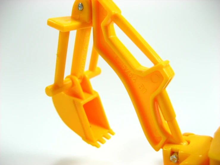 a yellow toy with a pair of hands with scissors on the inside