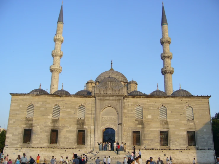 a group of people walking through a large building