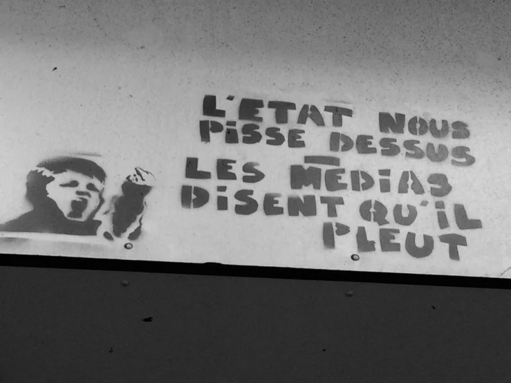 a sign depicting a man with a cigarette in his hand and the word presse press