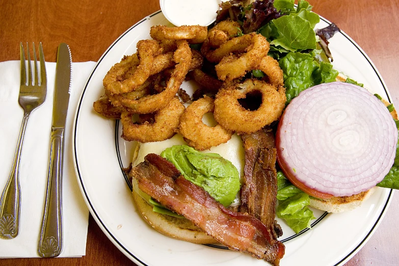 an onion rings sandwich is shown on the plate