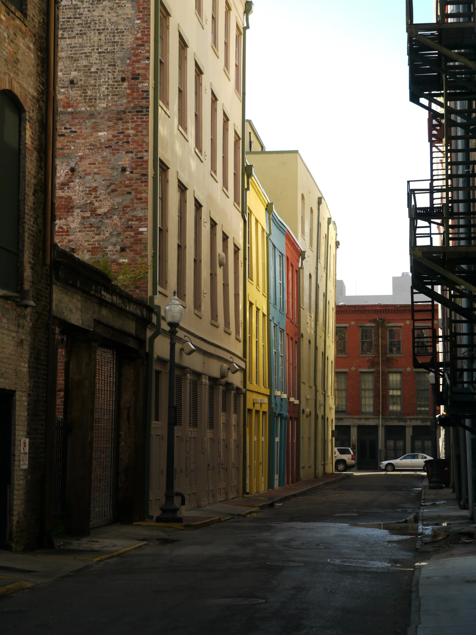 the brick buildings are lined with multi - colored shutters