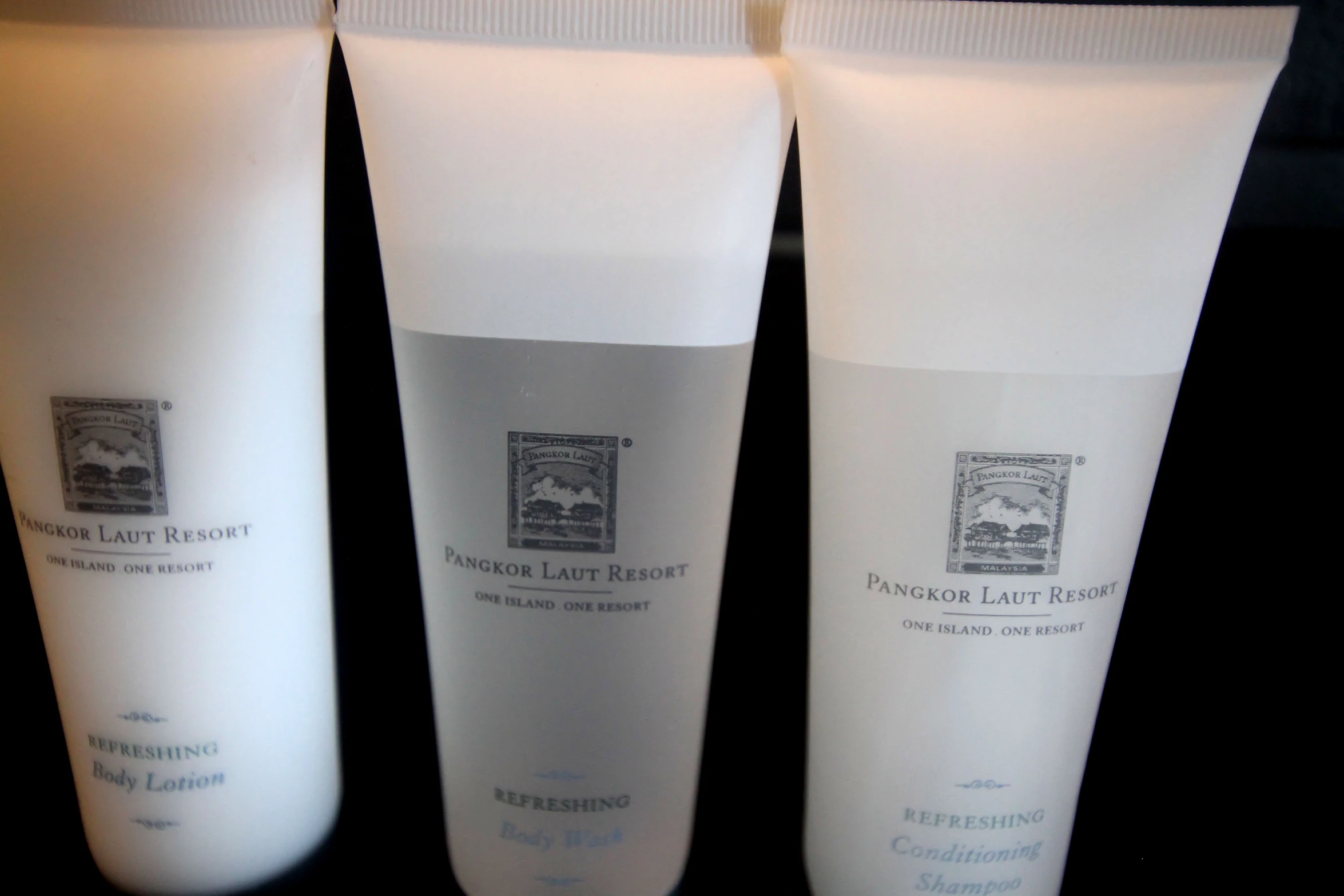 three white tube - sized tubes containing different ingredients