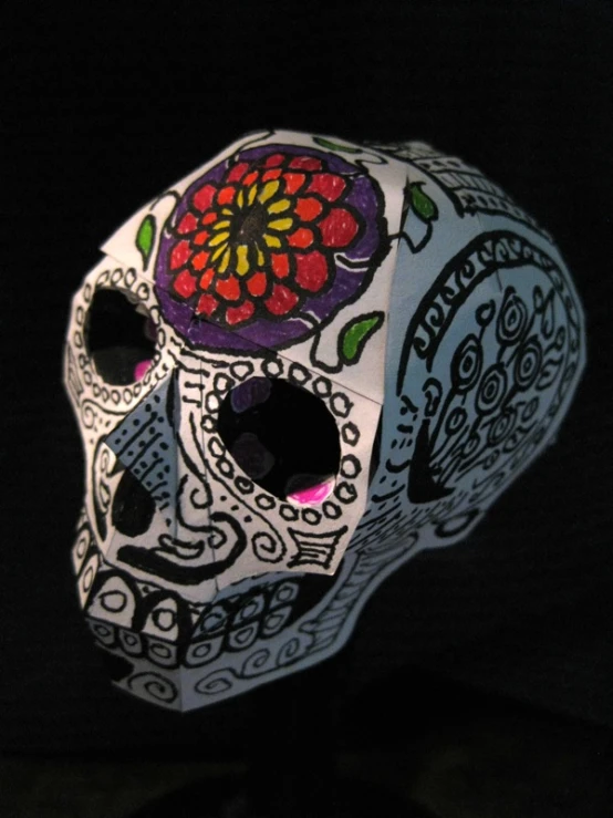 a decorated skull with colorful flowers is shown