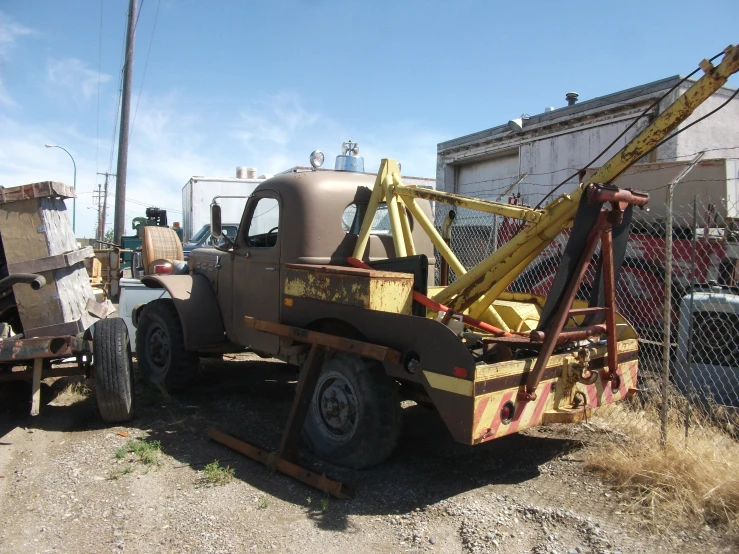 an old tow truck sitting in a parking lot