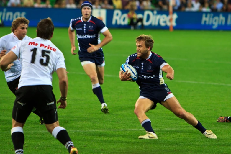 a player running with the ball near three opposing players