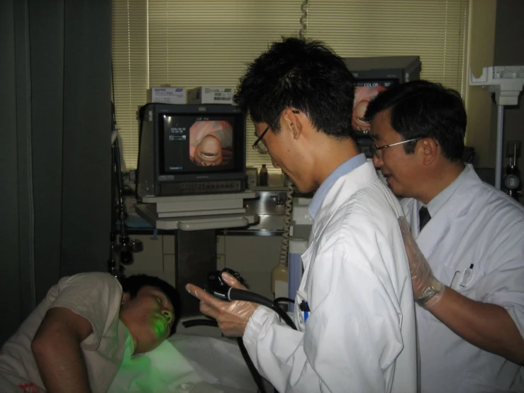 a nurse examining a patient's face while looking at the phone